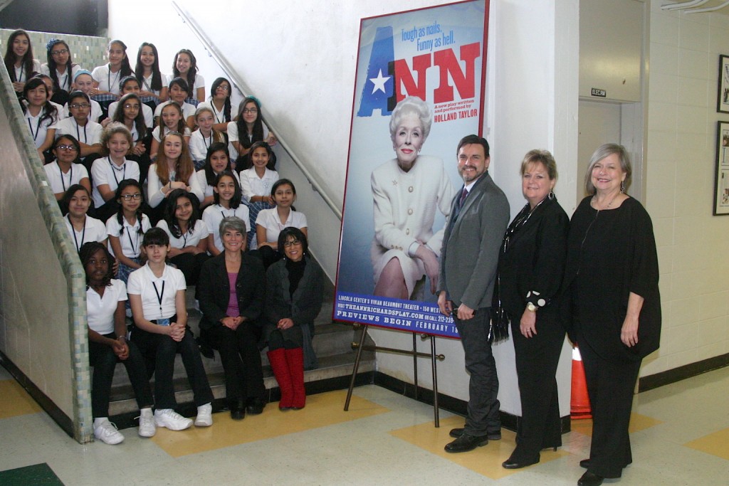 Ann Richards middle school students join Ann Richards School Foundation Board Members Ellen Richards, Chair Emeritus (seated, bottom row far left), Jeanne Goka, Principal of the Ann Richards School (seated, bottom row left), Beverly Dale, Board Member (standing, far right), Kathy Bolner, Board Chair (standing, right) as Barry Doss, Wardrobe Supervisor for the Broadway show 'ANN – the Ann Richards Play' (standing, right), presents the show’s poster from the Lincoln Center’s Vivian Beaumont Theater to the Ann Richards School as a gift from the Emmy and Tony Award nominated actress Holland Taylor.